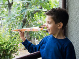 Kid throws paper plane