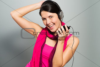 Beautiful vivacious woman listening to music