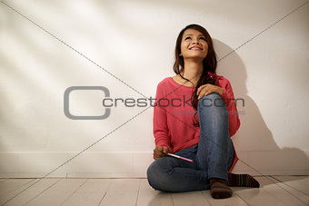 Happy Asian girl holding pregnancy test at home