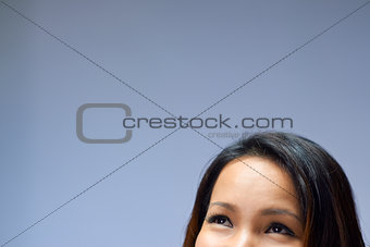 Portrait of Asian girl looking up and smiling