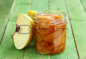quince jam confiture in  glass jar on a wooden table
