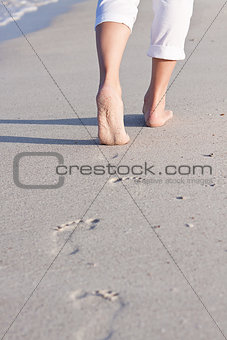 barefoot in the sand in summer holidays