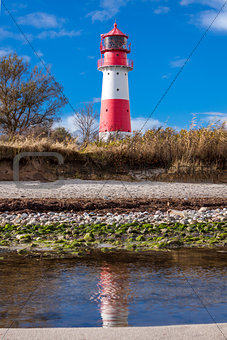landscape baltic sea dunes lighthouse in red and white 