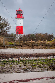 landscape baltic sea dunes lighthouse in red and white 