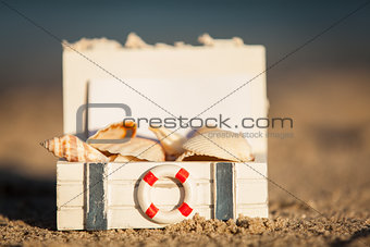 sailing boat and seashell in sand decoration closeup