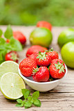 fresh tasty sweet strawberries and green lime outdoor in summer