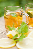 fresh tasty hot tea lemon and mint outdoor in summer 