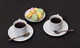 Two cups coffee and macaroon