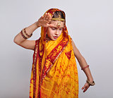 child in traditional Indian clothing and jeweleries dancing