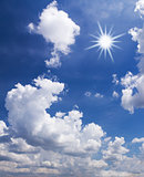 Blue sky with white clouds and sun