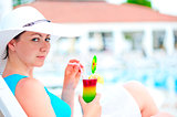 girl is resting on a sun lounger with a cocktail