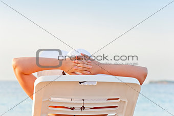 woman on vacation at the beach in a lounge chair