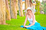 Girl resting on the lawn and laughs gaily