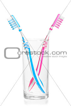 quarreled toothbrushes in a glass on a white background