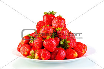 pile of garden strawberry on a plate isolated