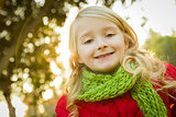 Little Girl Wearing Winter Coat and Scarf at the Park 