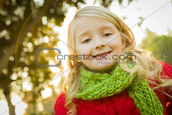 Little Girl Wearing Winter Coat and Scarf at the Park 