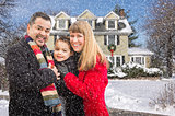 Mixed Race Family in Front of House in The Snow