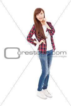 full length happy young woman talking on the phone