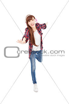 Young woman with headphones listening music and dancing
