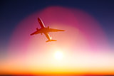 airplane with beautiful orange sunset background