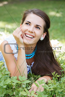 young woman lying on grass