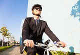 businessman riding a bicycle to workplace for protecting environ