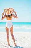 Full length portrait of young woman on beach. rear view