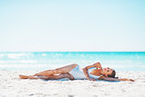 Young woman laying on beach