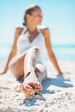 Closeup on young woman sitting on beach