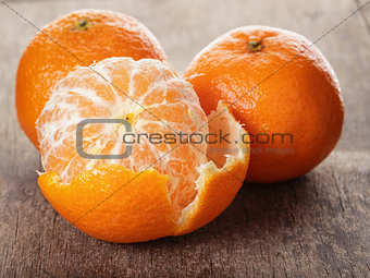 ripe tangerines closeup photo on wooden table
