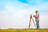 Surveyor engineer making measure on the field with tablet pc