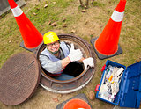  sewerage worker in the manhole with thumb up