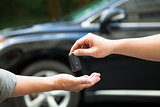 hands giving and receiving car key