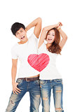 happy couple with love heart symbol design on the whit t shirt