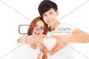 Young couple  making heart shape by hands