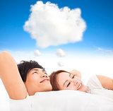 couple sleeping on the bed with dream cloud concept