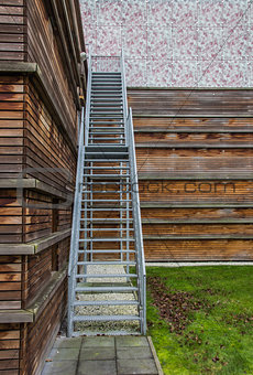 Steel stairs on a wooden building
