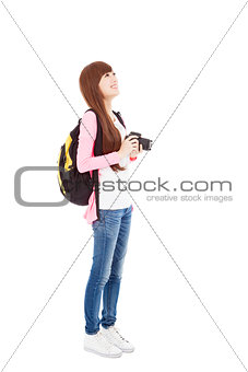 young woman backpacker holding a camera 