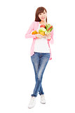 slim young woman holding fruits and vegetables