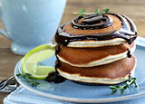 homemade pancakes with chocolate syrup and thyme