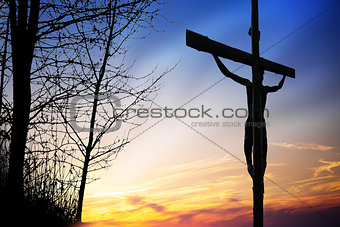Jesus on the cross at sunset
