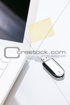 notebook laptop with post it memo and usb stick 