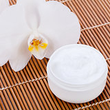 cosmetic face cream on wooden background 