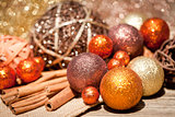 glittering christmas decoration in orange and brown natural wood 