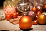 glittering christmas decoration in orange and brown natural wood 