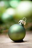 shiny green christmas baubles closeup macro and tree 