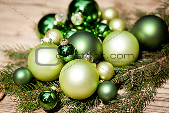 shiny green christmas baubles closeup macro and tree 