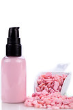 pink body lotion in dispenser and aroma salt isolated
