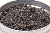 Black caviar in metal can, high angle
